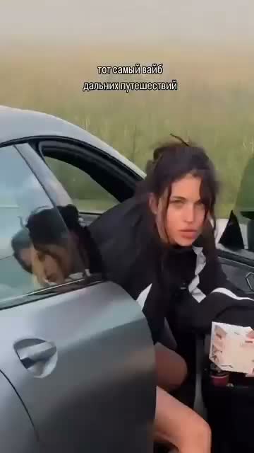 Third performer beside the car