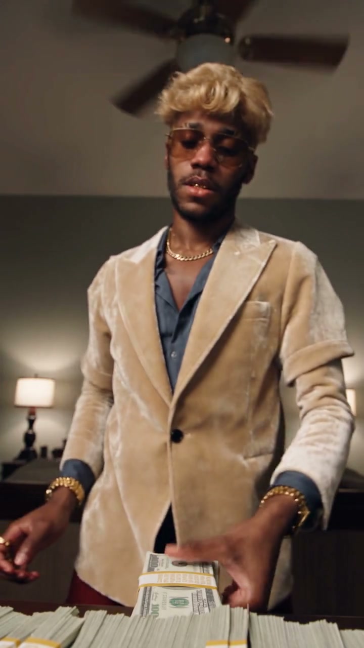 Community example wearing a cream jacket among the bills