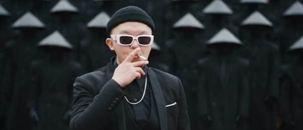Community STORM II adaptation with a black-clad lead and a crowd wearing conical hats